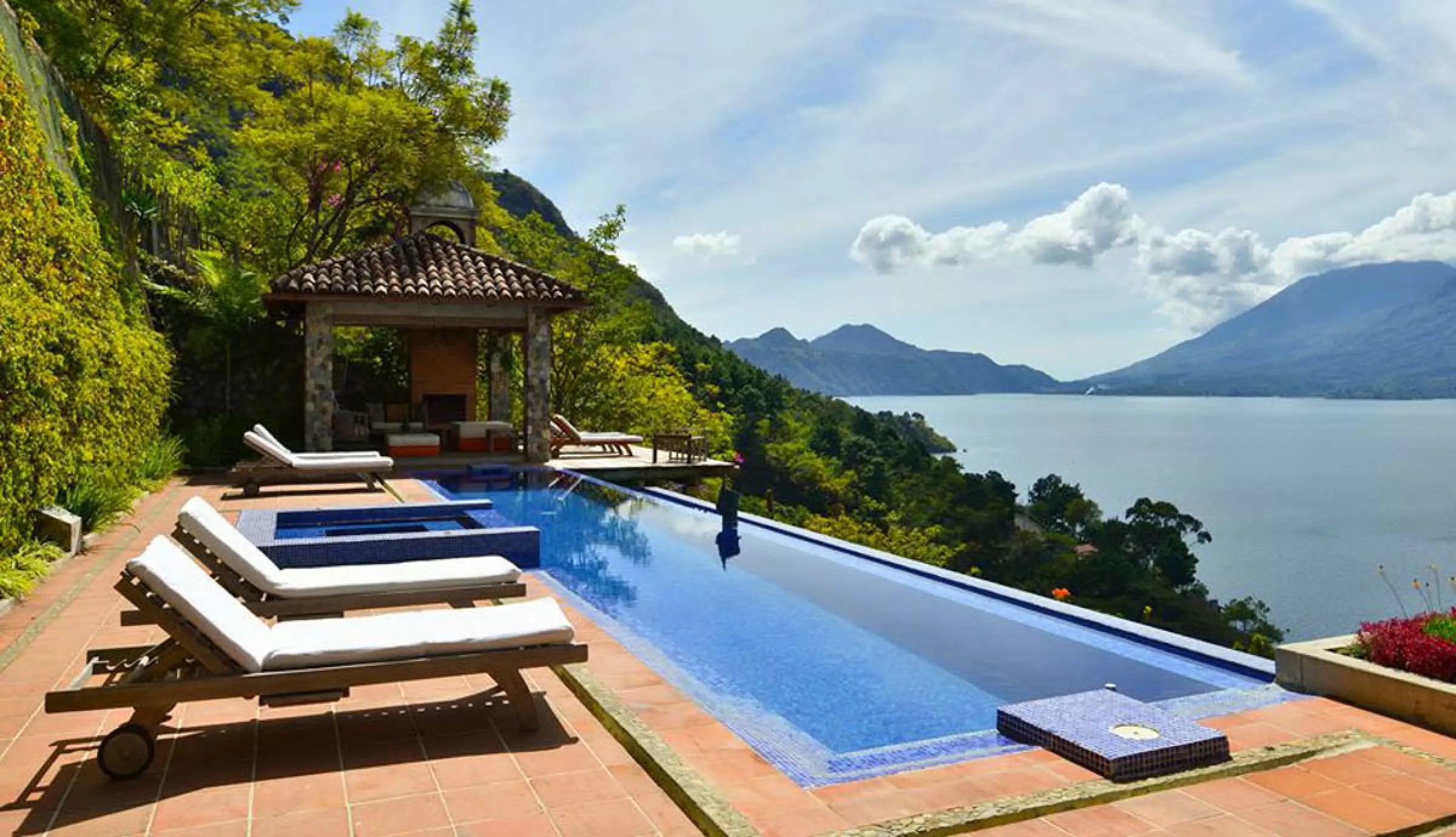 Terraced house above a lake with volcanic slopes on the far shore
