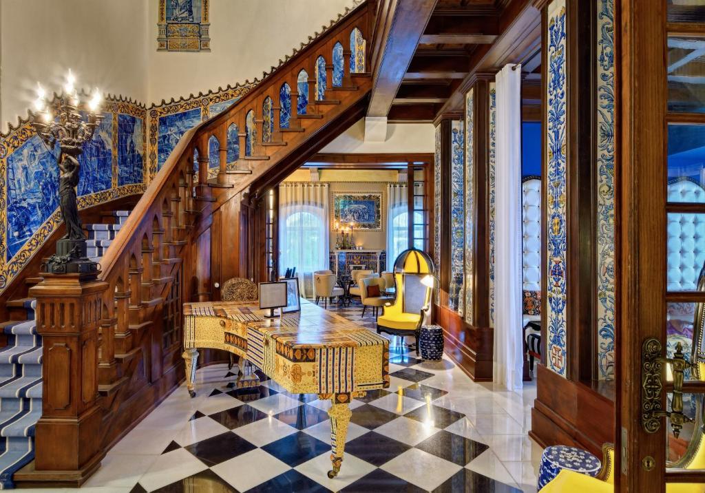 Tiled stair hall with carved woodwork and a coloured glass window