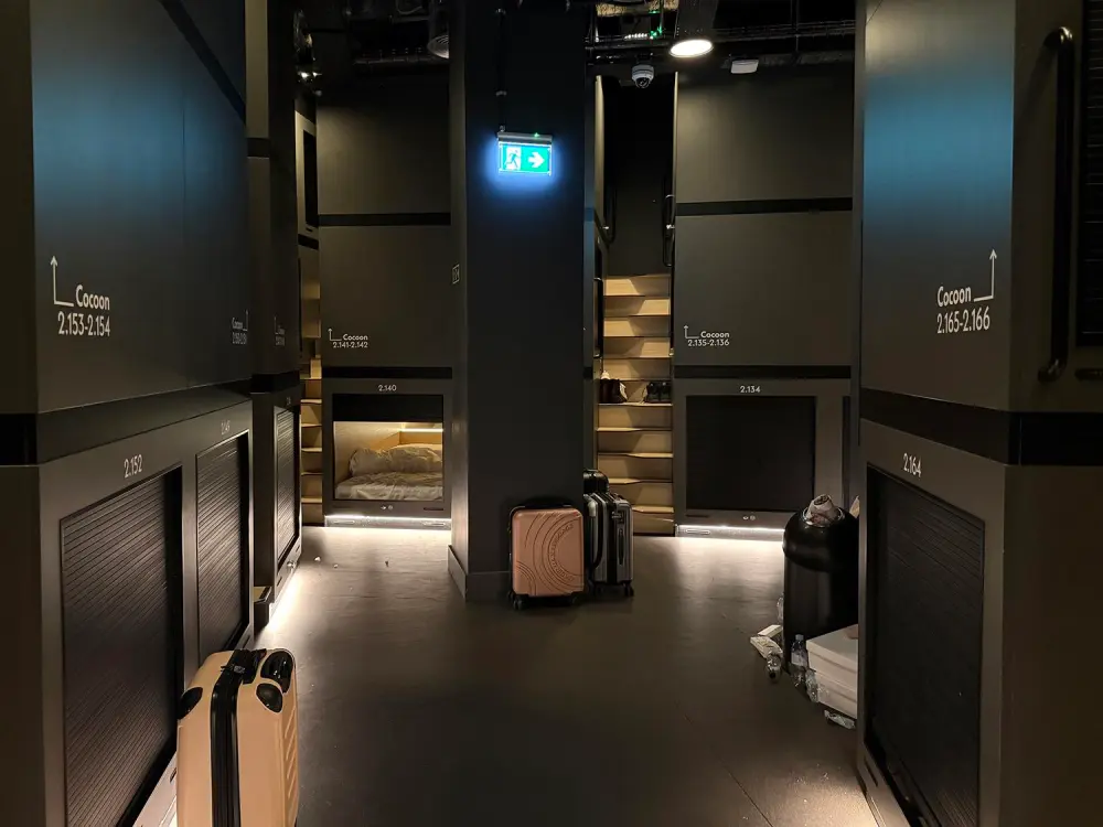 Narrow interior corridor lined with stacked compact sleeping berths