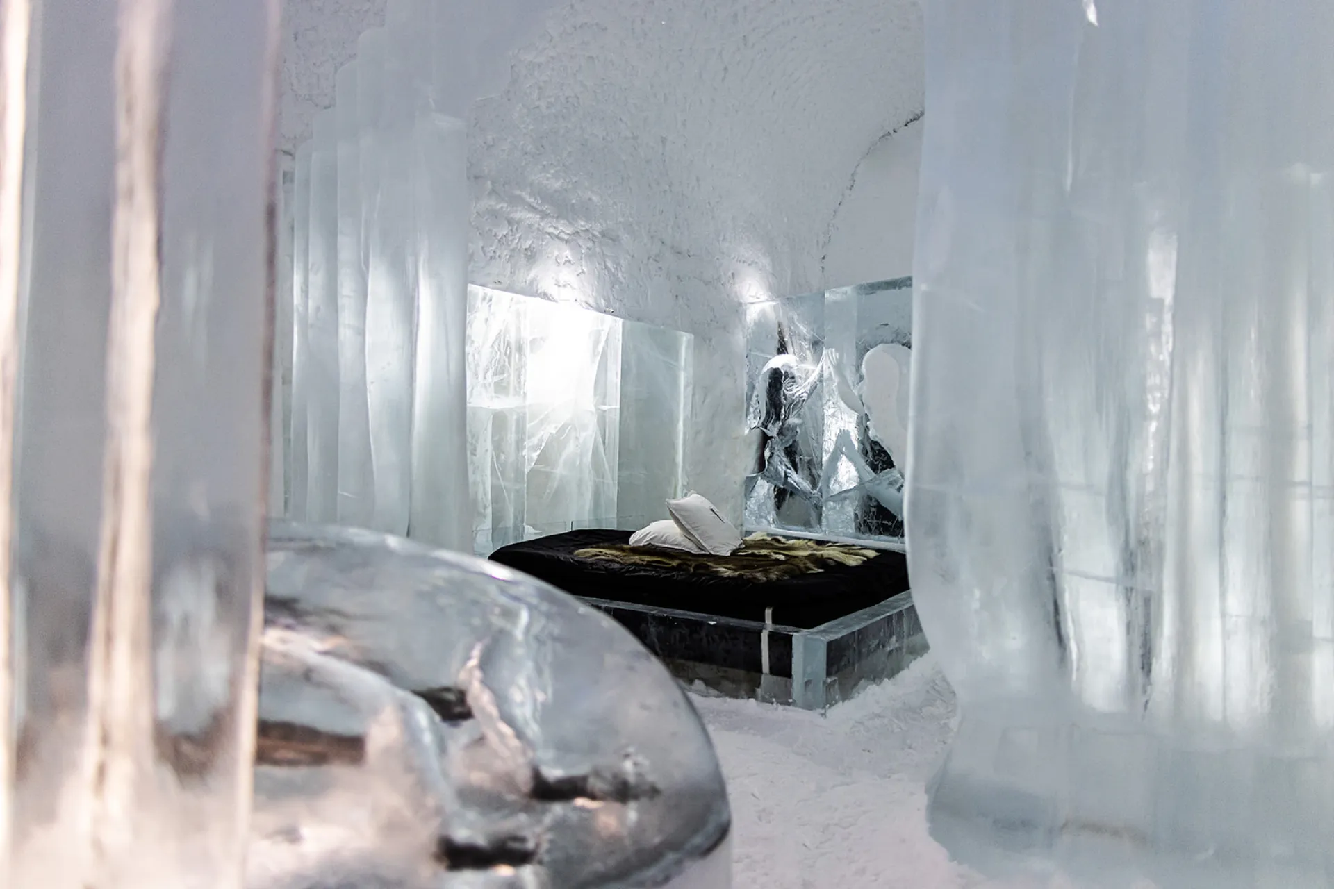 Vaulted corridor of packed snow with carved openings along both sides